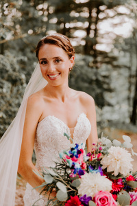 Caitlin on her wedding day with her bouquet in her hands.