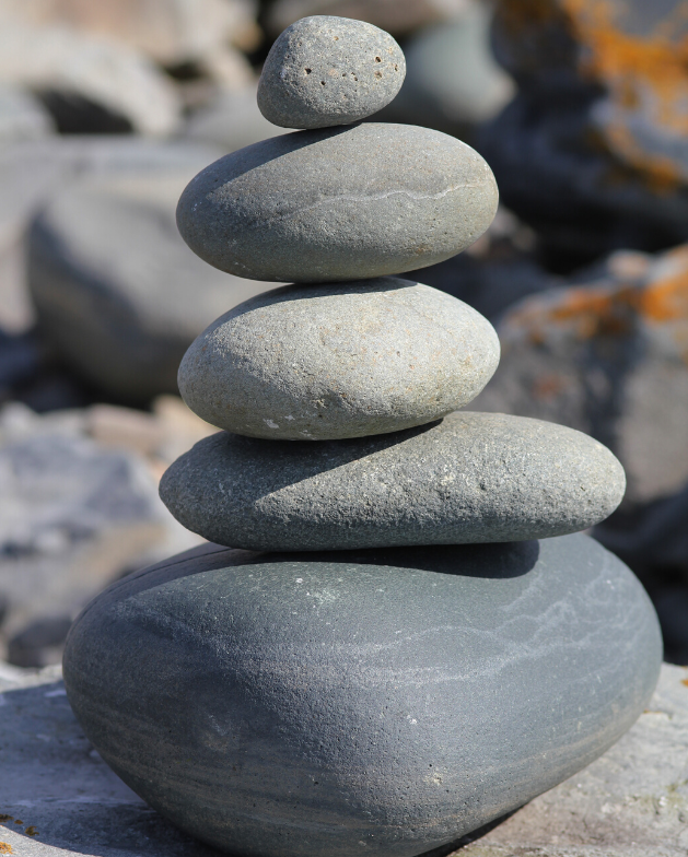 Smooth stones decreasing in size are stacked on one another.